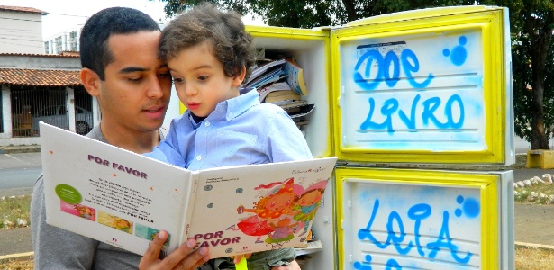 Nícolas Heero, de 3 anos, lê livro da geladeira com seu pai Renê Elvis